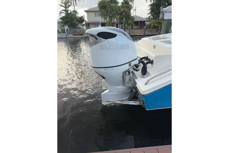  Yacht Photos Pics 2021 Marlin 39 CC boat with Suzuki outboard motor docked by waterfront.