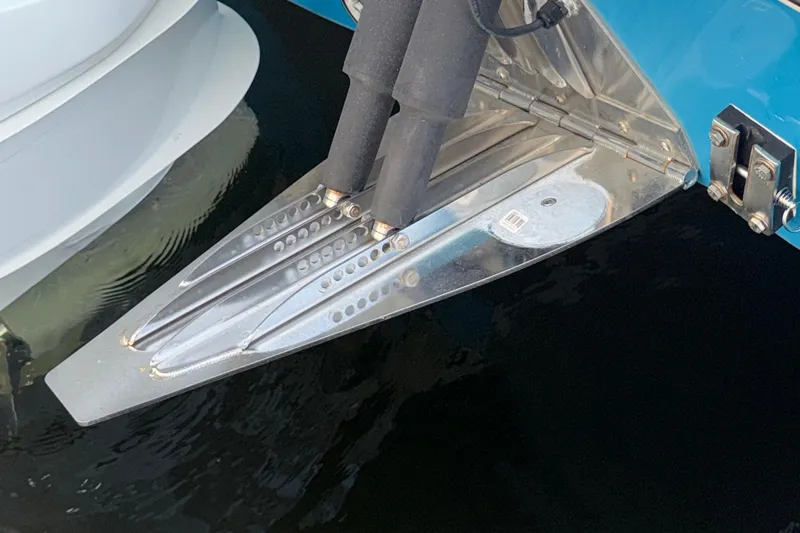  Yacht Photos Pics Trim tabs on a 2021 Marlin 39 CC boat, reflecting in water.