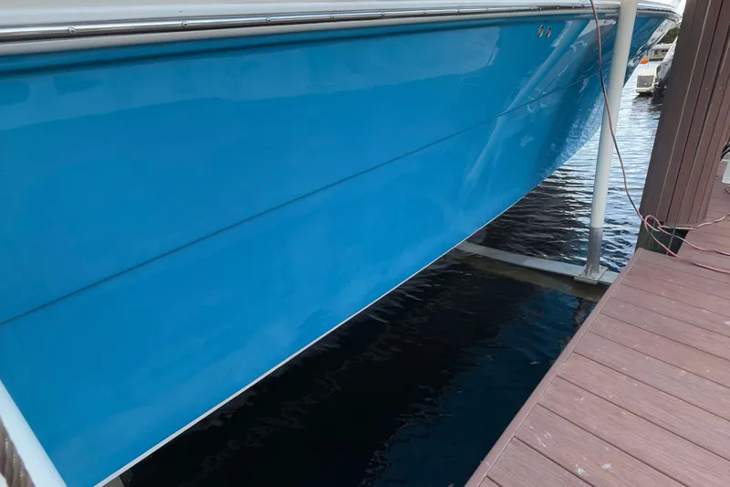  Yacht Photos Pics 2021 Marlin 39 CC boat docked, featuring a sleek blue hull design.