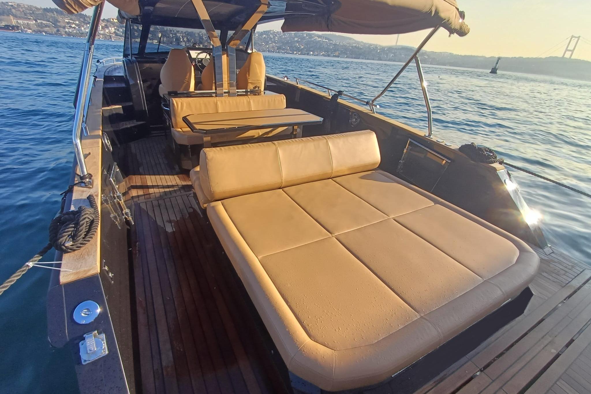 Luxurious 2024 Focus Forza 37 yacht interior with sunbed and seating on open water.