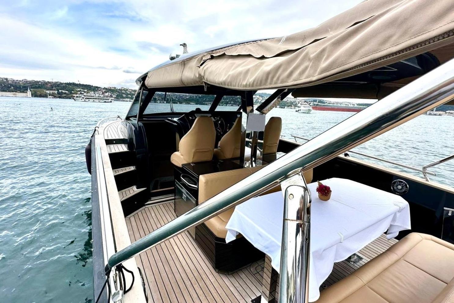 Luxurious 2024 Focus Forza 37 yacht with elegant seating and dining area on open water.