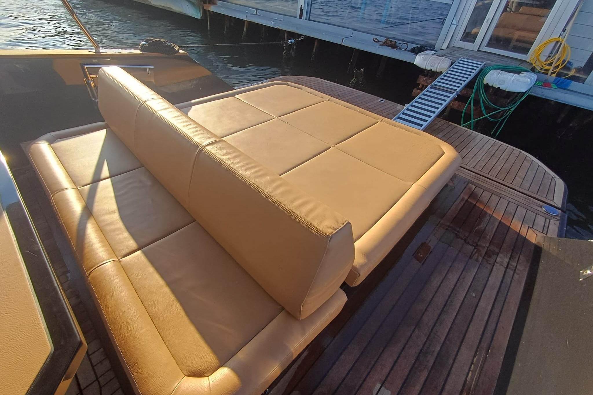 Luxury seating on 2024 Focus Forza 37 yacht, docked by the water.