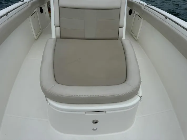 Rocco Yacht Photos Pics 2020 Boston Whaler 330 Outrage boat seating area with cushioned seat.