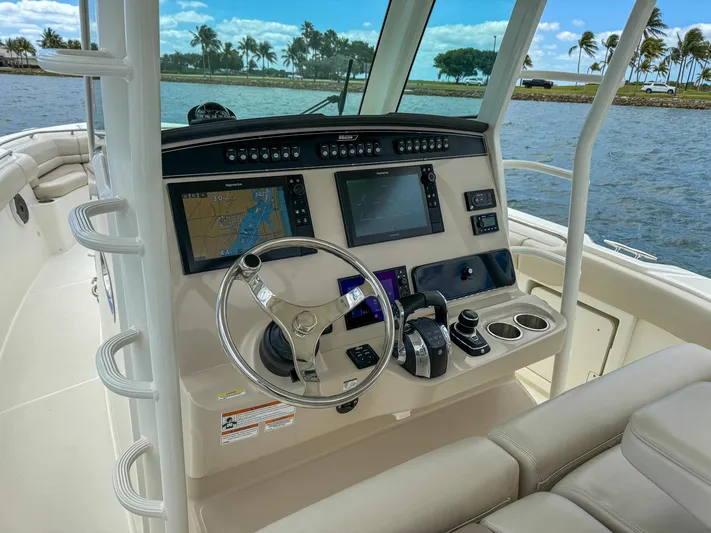 Rocco Yacht Photos Pics 2020 Boston Whaler 330 Outrage boat helm with navigation screens and controls.