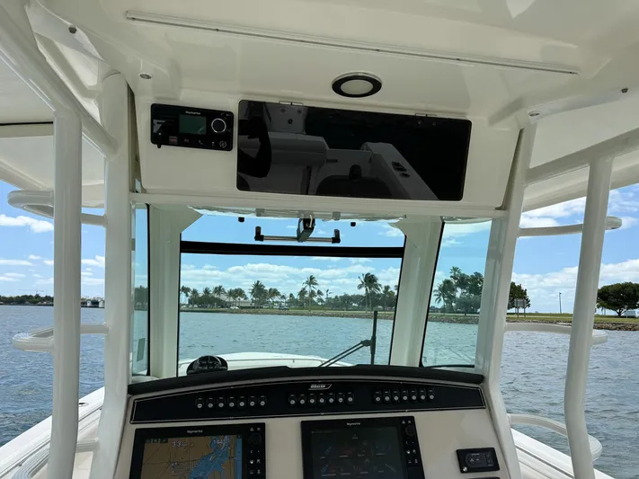 Rocco Yacht Photos Pics 2020 Boston Whaler 330 Outrage helm with advanced navigation systems and waterfront view.