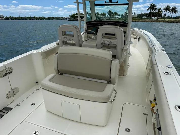 Rocco Yacht Photos Pics 2020 Boston Whaler 330 Outrage boat interior with seating and helm, docked on a sunny day.