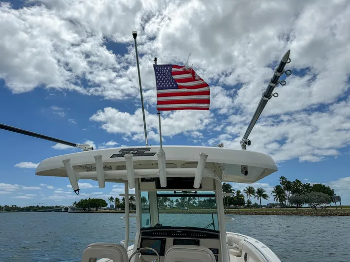 Rocco Yacht Photos Pics 2020 Boston Whaler 330 Outrage boat with American flag on a sunny day.