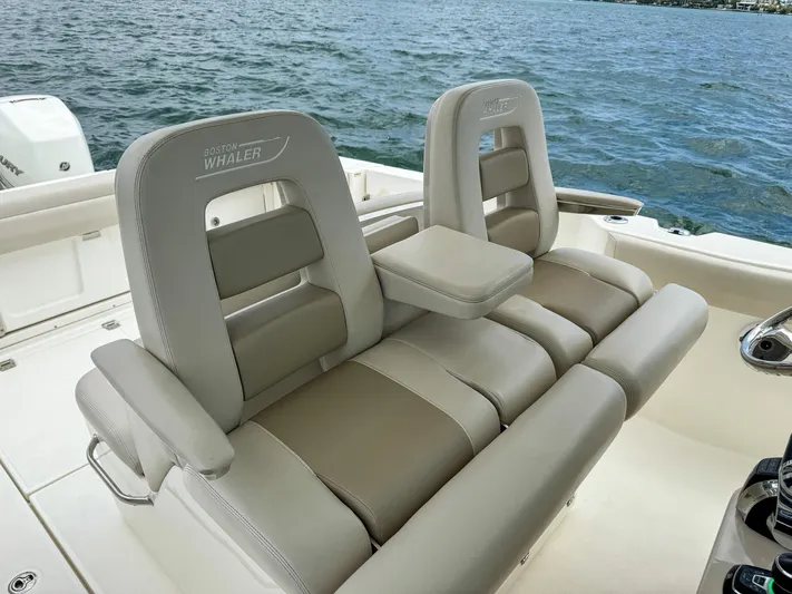Rocco Yacht Photos Pics Luxury seating on 2020 Boston Whaler 330 Outrage boat with ocean backdrop.
