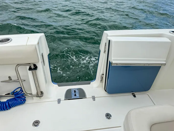 Rocco Yacht Photos Pics Boston Whaler 330 Outrage 2020 model with open transom door on the water.