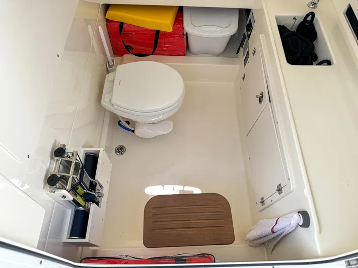 Rocco Yacht Photos Pics 2020 Boston Whaler 330 Outrage boat bathroom with toilet and storage compartments.