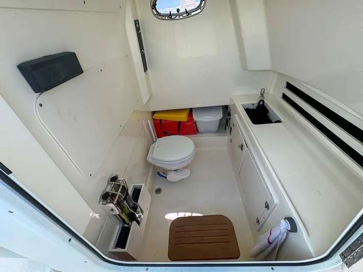 Rocco Yacht Photos Pics 2020 Boston Whaler 330 Outrage boat cabin with toilet and sink.