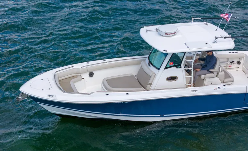 Rocco Yacht Photos Pics 2020 Boston Whaler 330 Outrage boat cruising on open water.