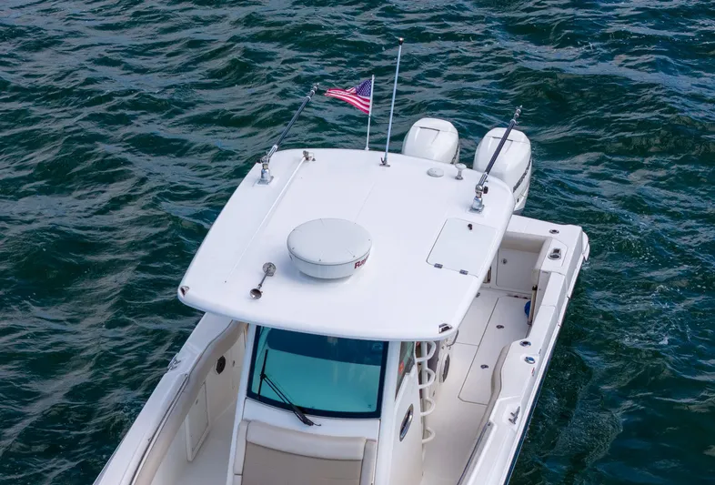 Rocco Yacht Photos Pics 2020 Boston Whaler 330 Outrage boat on water with American flag.