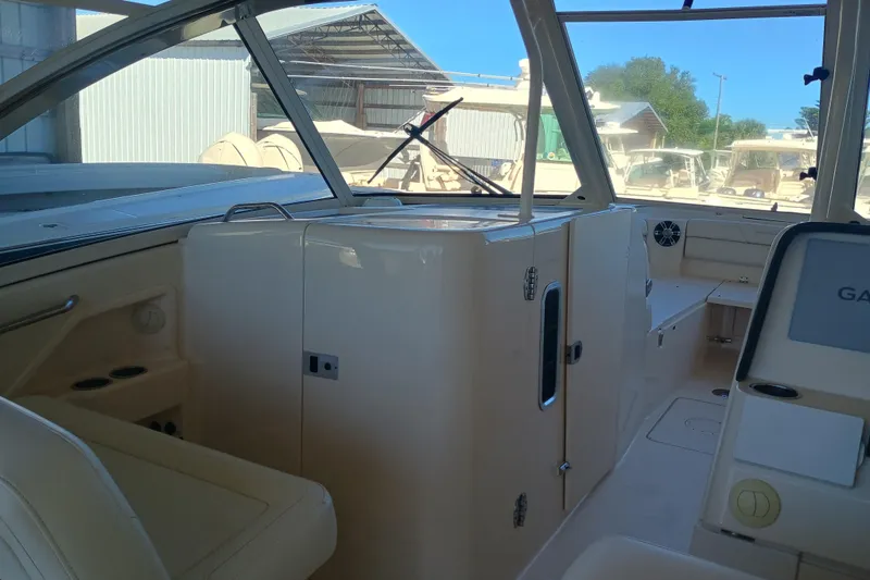 325-708 Brokerage Josh Yacht Photos Pics 2021 Grady-White Freedom 325 boat interior with seating and storage compartments.