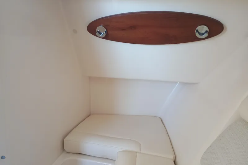 325-708 Brokerage Josh Yacht Photos Pics Interior of 2021 Grady-White Freedom 325 boat, featuring cushioned seating and wooden accents.