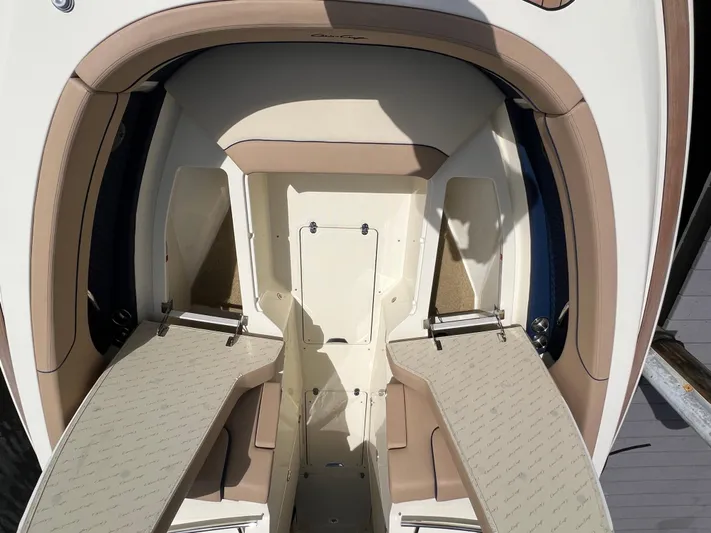 Yacht Photos Pics 2024 Chris-Craft Calypso 32 boat interior with beige seating and storage compartments.