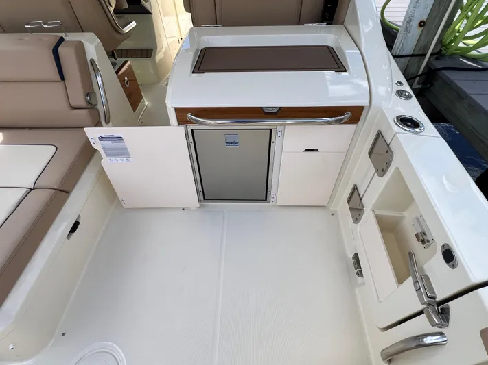  Yacht Photos Pics 2024 Chris-Craft Calypso 32 interior with seating and storage compartments.