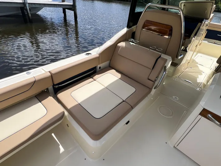  Yacht Photos Pics 2024 Chris-Craft Calypso 32 boat interior with beige seating by the water.