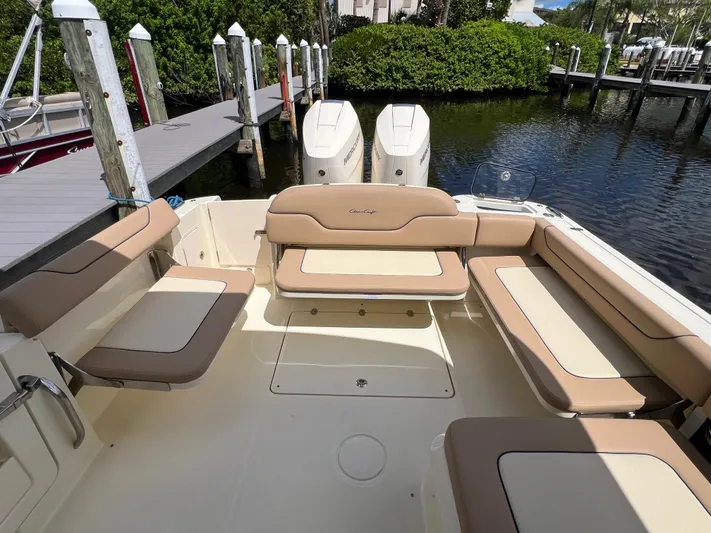  Yacht Photos Pics 2024 Chris-Craft Calypso 32 boat interior with beige seating and twin engines.