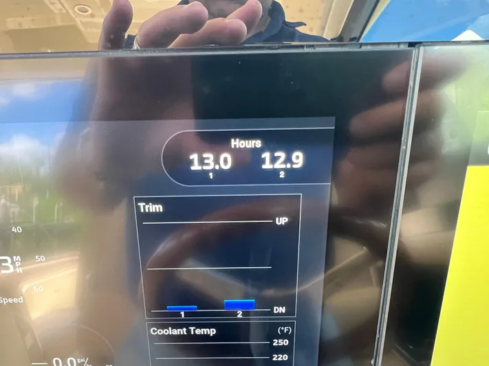  Yacht Photos Pics Display screen of 2024 Chris-Craft Calypso 32 showing engine hours and trim settings.