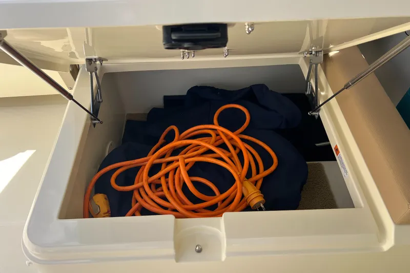  Yacht Photos Pics Storage compartment in 2024 Chris-Craft Calypso 32 with orange extension cord.