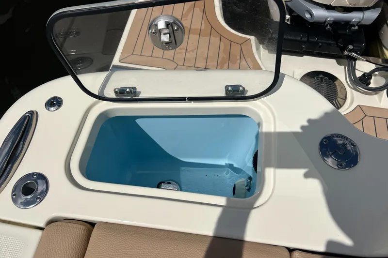  Yacht Photos Pics 2024 Chris-Craft Calypso 32 boat with open storage compartment and teak flooring.