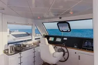 Luxurious yacht helm with ocean view, featuring modern controls and comfortable seating, Custom Canyon 92, 2024.