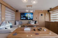 Luxurious yacht interior with modern decor, featuring a TV and elegant lighting, Custom Canyon 92, 2024.