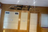Fishing rods mounted on a wooden wall inside a Custom Canyon 92, 2024 model.