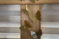 Decorative metal butterflies on wooden panel, Custom Canyon 92, 2024 model.