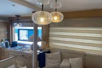 Luxurious interior of 2024 Custom Canyon 92 yacht with elegant lighting and cozy seating.