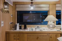 Luxurious interior of 2024 Custom Canyon 92 yacht with elegant wooden cabinetry and modern decor.