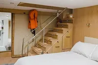 Luxurious bedroom interior on 2024 Custom Canyon 92 yacht, featuring modern design and wooden accents.