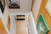 Staircase with colorful animal paintings on walls, Custom Canyon 92, 2024 model.
