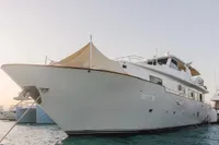 Luxury yacht Custom Canyon 92, 2024 model, docked in serene waters.