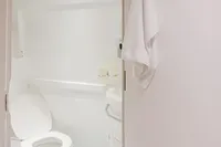 Compact bathroom in 2024 Custom Canyon 92, featuring modern fixtures and white decor.