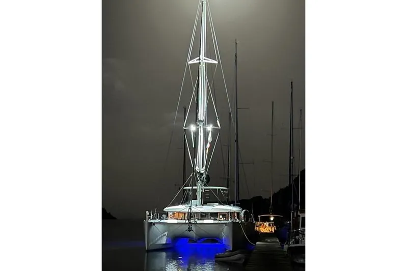  Yacht Photos Pics 2018 Lagoon 450 F catamaran illuminated at night with blue underwater lights.