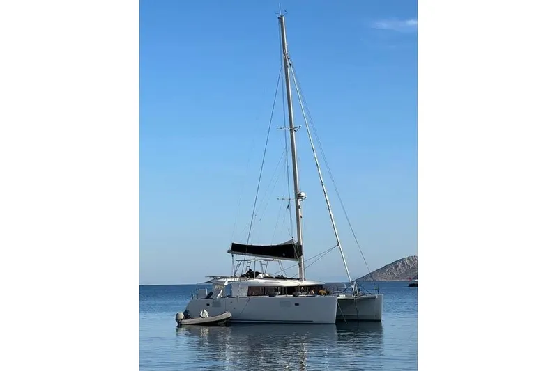  Yacht Photos Pics 2018 Lagoon 450 F catamaran anchored in calm blue waters.