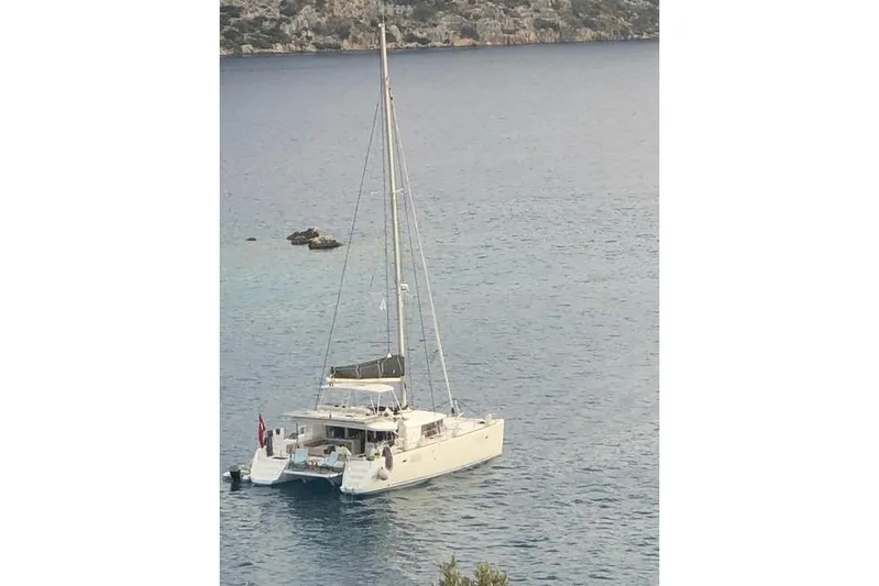  Yacht Photos Pics 2018 Lagoon 450 F catamaran anchored in serene waters.