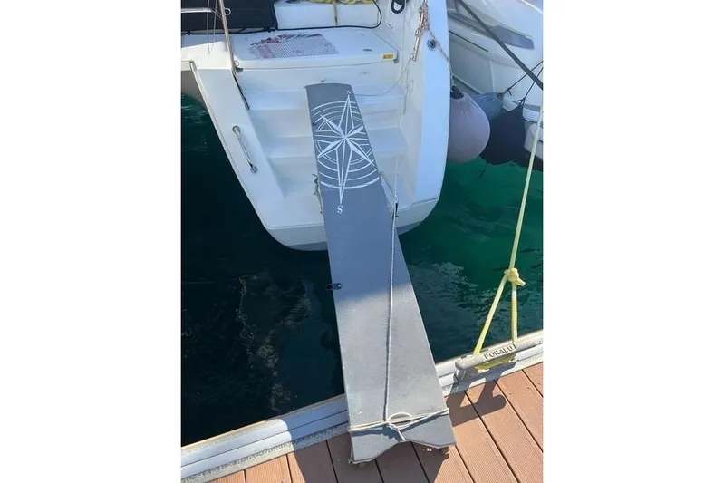  Yacht Photos Pics Lagoon 450 F 2018 yacht with gangway and compass design, docked at marina.