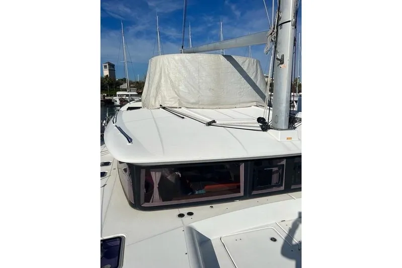  Yacht Photos Pics 2018 Lagoon 450 F catamaran docked, featuring sleek design and covered sail.