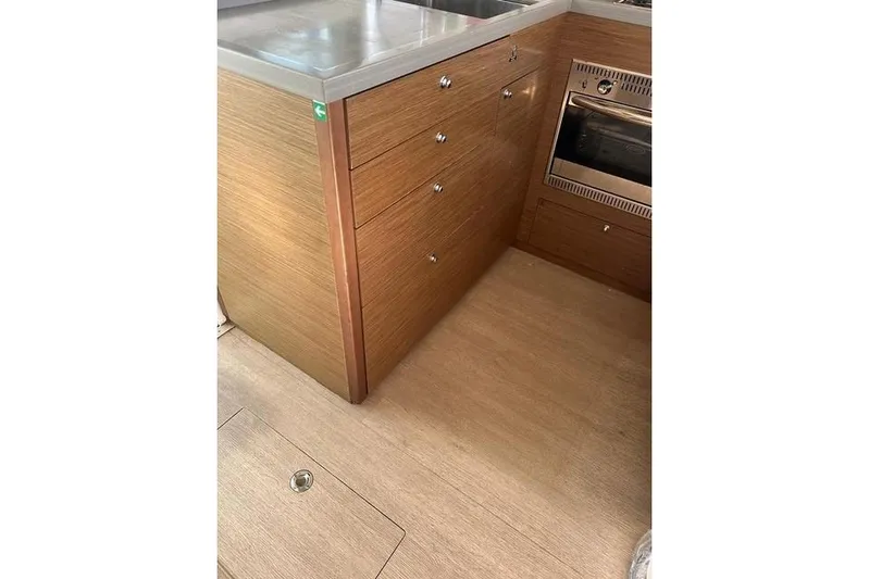  Yacht Photos Pics Interior of 2018 Lagoon 450 F yacht kitchen with wooden cabinetry and stainless steel appliances.