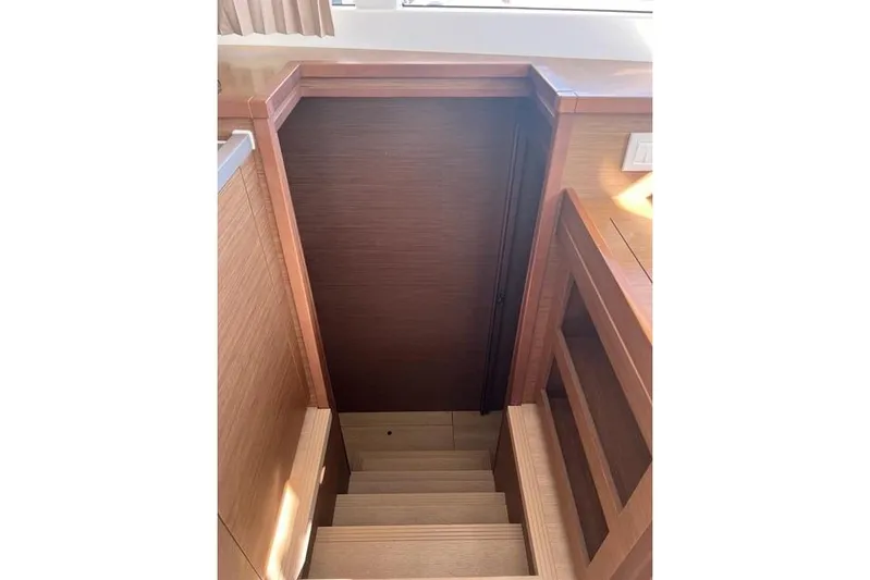  Yacht Photos Pics Wooden staircase inside 2018 Lagoon 450 F yacht, leading to lower cabin area.
