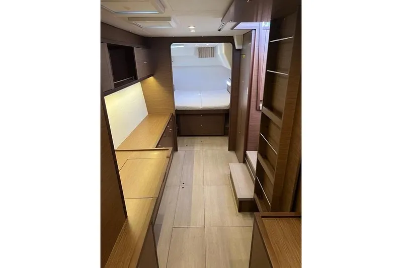  Yacht Photos Pics Interior of 2018 Lagoon 450 F yacht, featuring wood finishes and a cozy sleeping area.