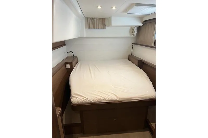 Yacht Photos Pics Cozy bedroom interior of 2018 Lagoon 450 F yacht with modern design and soft lighting.