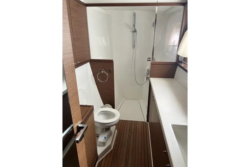  Yacht Photos Pics 2018 Lagoon 450 F yacht bathroom with wood accents and modern fixtures.