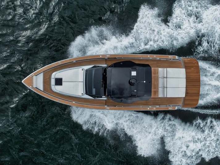  Yacht Photos Pics Aerial view of 2022 Pardo Yachts 43 cruising on water, showcasing sleek design and wooden deck.