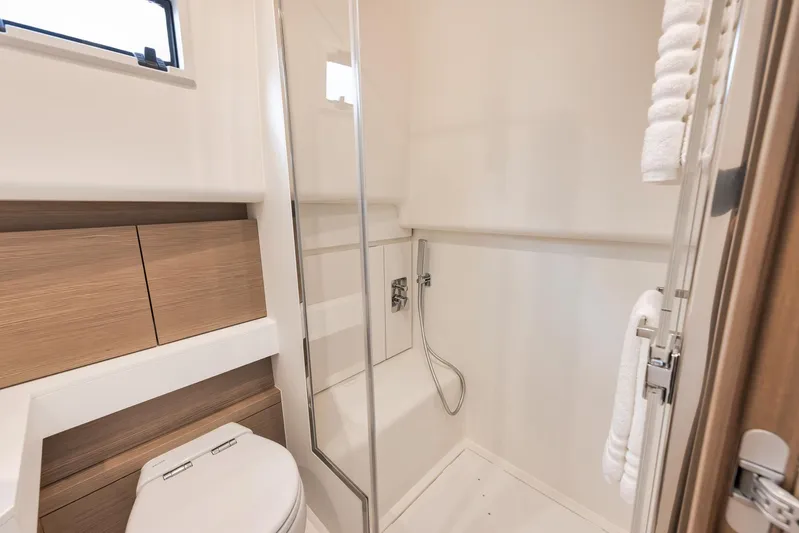  Yacht Photos Pics Luxurious bathroom in 2022 Pardo Yachts 43, featuring modern fixtures and elegant wood accents.