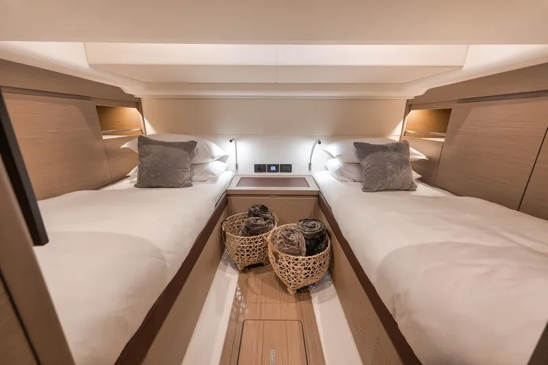  Yacht Photos Pics Luxurious twin cabin interior of 2022 Pardo Yachts 43, featuring elegant bedding and ambient lighting.