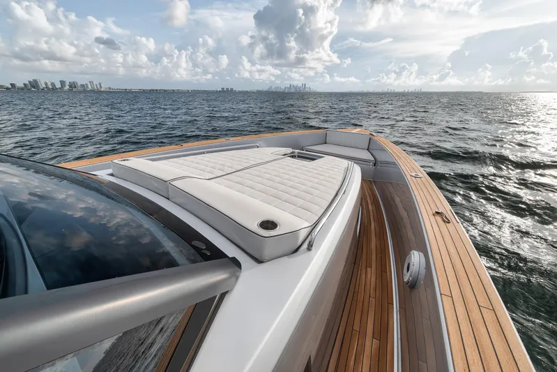  Yacht Photos Pics Luxurious 2022 Pardo Yachts 43 cruising on open water with city skyline in background.